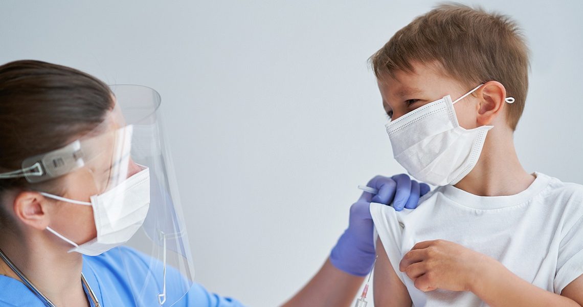 Portrait of adorable little boy being vaccinate at doctor's office